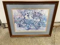 Front view of framed rabbit artwork showing design, colors, and wooden frame.