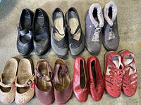 Full lot view showing 7 pairs of different styles of women's shoes in varied colors and brands