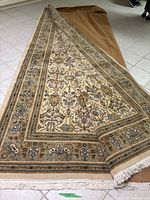 Rug folded lengthwise to show overall pattern and size