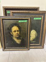 Overview of three framed paintings stacked