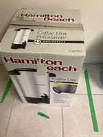 Photo of unopened box showing Hamilton Beach branding, coffee urn model C40515, 42 cup capacity