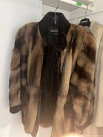 Front view of brown mink fur coat showing pattern, leather trim on collar and cuffs