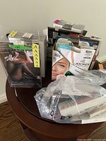 Wide view of multiple packages of hosiery and socks stacked together, including brands Silks and Jockey.