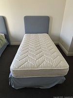 Front view of twin bed with headboard and mattress