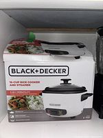 Black and Decker 16-cup rice cooker and steamer in original box showing the product image and features.