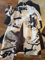 Both coats laid flat, showing front of printed Etro coat over grey coat