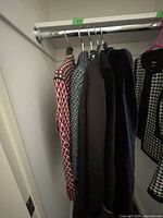 Overview of five jackets hanging on metal rack
