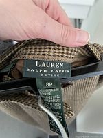 Close-up of label reading Lauren Ralph Lauren Petite 8P and fabric composition 100% lambswool