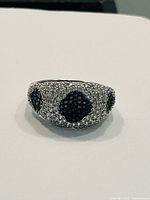 Front-facing image of the sterling silver ring showing clear and black Swarovski crystals in diamond patterns.