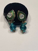 Front view of blu seaglass earrings with Swarovski crystal, displayed on black stand