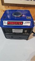 Front view of blue Powertek LT950 portable generator showing front controls and branding.