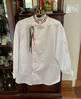 Front view of large white chef coat with Italian colored trim on collar, showing front and sleeve pocket