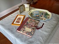 Overall view of all items on display including tray, album, framed photo, and clock/frame set.