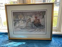Full frontal image of the framed artwork 'Evening Skaters' showing winter skating scene in gold frame.