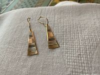 Pair of earrings laid flat showing front view of tricolour stripes