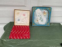 Two boxed sets of vintage ladies handkerchiefs: one Eatons of Canada boxed set with 3 colorful apple embroidered handkerchiefs and one Fruit of the Loom set with blue floral embroidery