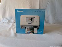 Front photo of Canon Selphy CP720 photo printer box showing product image and branding.