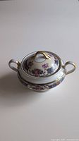 Vintage Eichwald sugar bowl with floral pattern and gold detailing on a white table showing top and side views