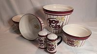 Full display of the popcorn set includes one large bowl, three smaller bowls, and two shakers with popcorn and striped red motif
