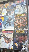 Photo showing an arrangement of seven Beckett hockey magazines with colorful covers featuring various 1990s NHL players and teams.