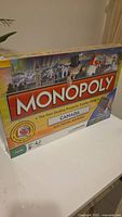 Front and side of Monopoly Canada electronic banking board game box showing branding and age suitability