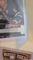 Close-up of Mark Messier hockey card in protective casing showing serial number 13/75.