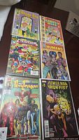 Photo showing six #1 issue comics including Marvel Power Man and Iron Fist #1 and others like Royal Roy, Richie Rich & Scooby-Doo, The Ruscals, The Humans, and Tenderloin.