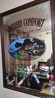 Full view of vintage Southern Comfort bar mirror showing the scenic illustration and wooden frame.