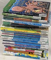 View of 20 stacked children's books showing titles and spines