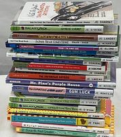 Stack of 20 children's books showing various colorful covers and spines with titles and authors clearly visible