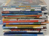 Stack of 20 children's books seen from the side with visible titles and author names.