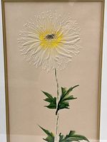 Close-up photo of the embossed daisy print showing the texture and colors of the flower and leaves.