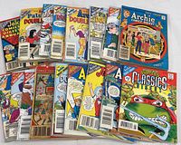 Photo showing all 12 comic digests spread out in two rows, mostly Archie titles with one TMNT comic, color illustrated covers visible.
