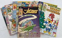 Front view of several comic books including The Jetsons 1st issue, Worry Woodpecker holiday special, and other vintage comics in used condition with intact covers.