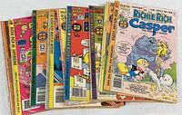 Photo showing a set of 12 Richie Rich comic books fanned out, including issues of Richie Rich Superschool, Richie Rich Bank Books, and Casper the Friendly Ghost as Richie Rich's friend.