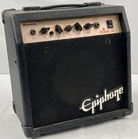 Front view of black Epiphone Studio 10 guitar amp showing controls, input jack, power switch and speaker grille.