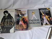 Four books about Freddie Mercury and Queen laid out side by side showing front covers