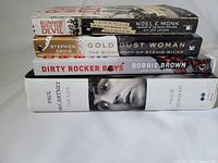 Stack of four books featuring front cover titles and authors, showing the Paul McCartney hardcover at bottom.