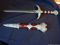 Full view of the sword alongside the scabbard, showing the overall length and design.