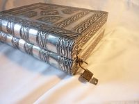 Close-up of corner and lock on embossed metal exterior resembling books