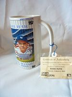 Front and handle view of ceramic stein depicting Babe Ruth portrait and stadium background with certificate of authenticity attached.