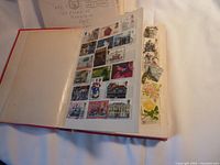 Open stock book page showing colorful postage stamps with diverse themes