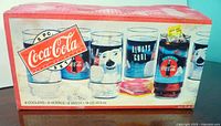 Original box showing set of 8 Coca-Cola glasses with polar bear and Coca-Cola logos, box shows wear and tear.