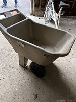 View of the lawn cart showing its deep tub and sturdy structure.