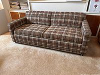 Front view of the plaid tweed loveseat sofa showing overall condition and fabric pattern.