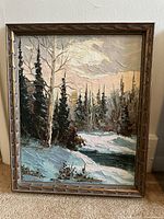 Full view of the framed oil painting showing the snowy woodland scene with birch and evergreen trees, snow-covered ground, and a river.