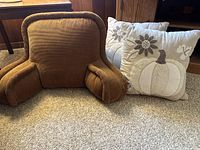 Front angled view of brown corduroy back pillow and fall-themed decorative pillow showing size and fabric textures.