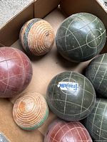 Close-up of bocce balls highlighting the Franklin brand label and condition of green bocce balls with grid lines.