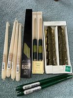Lot showing all vintage new candles including Bougie tapers on left, boxed Hallmark Dipped Danish Tapers in center, green tree candles on right, and other green candles at front