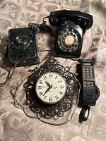Full view of the lot showing the General Electric kitchen wall clock and three vintage phones: rotary dial, antique box phone, and Rochester Tel handset phone.